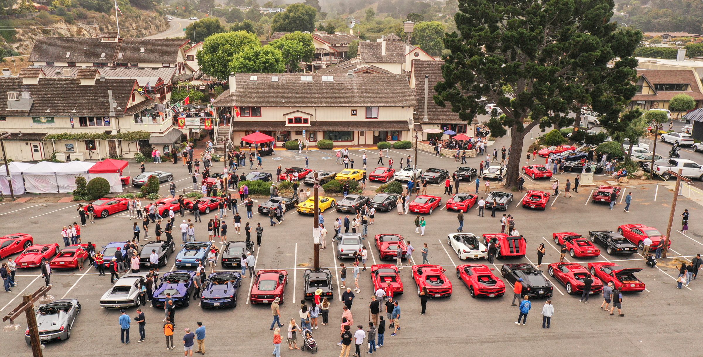 Aerial view of the 28th Annual Ferrari Event at The Barnyard with dozens of Ferraris parked outside O'Callaghan's Irish Pub in Carmel during Monterey Car Week